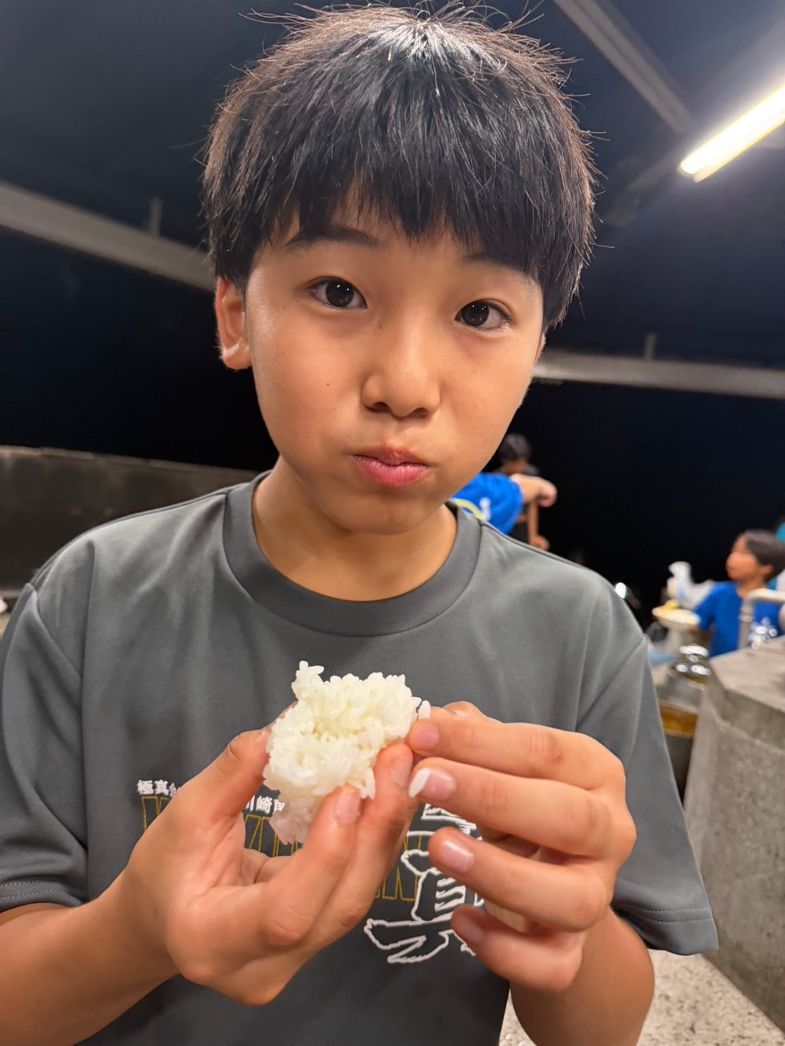 塩おにぎりを手に持つ子供